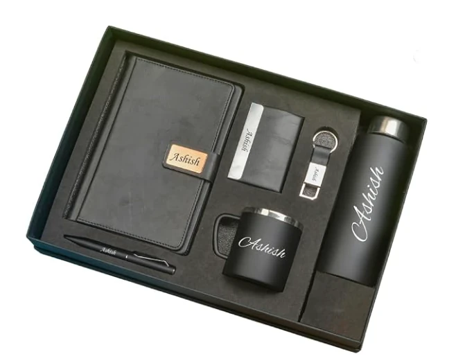 Personalized black gift set with a notebook, wallet, key ring, pen, mug and insulated bottle in a fitted presentation box