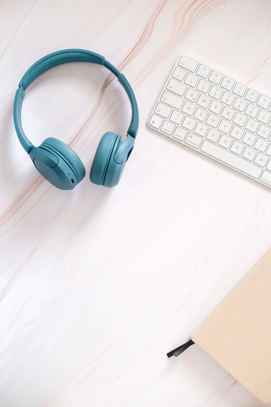 Illustrative headphones and keyboard in a modern workspace